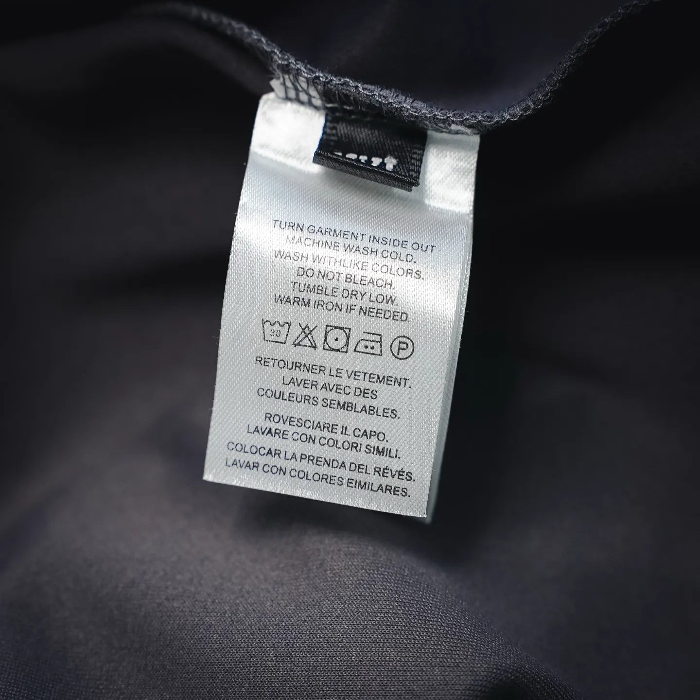 Inside care label on dark gray pants