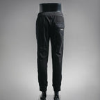 Prada black pants, side view with PRADA logo patch near pocket
