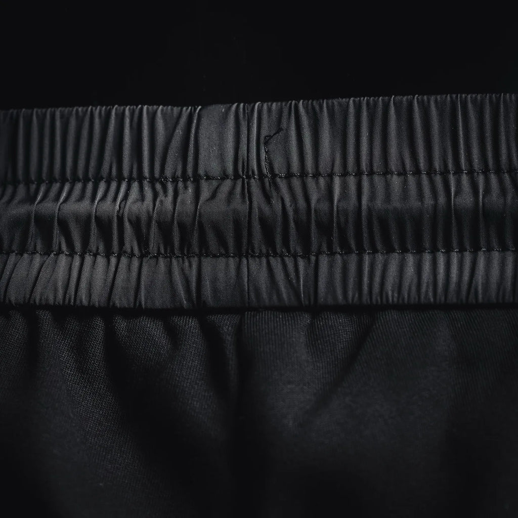 Prada black pants close-up of elastic waistband and stitched seams