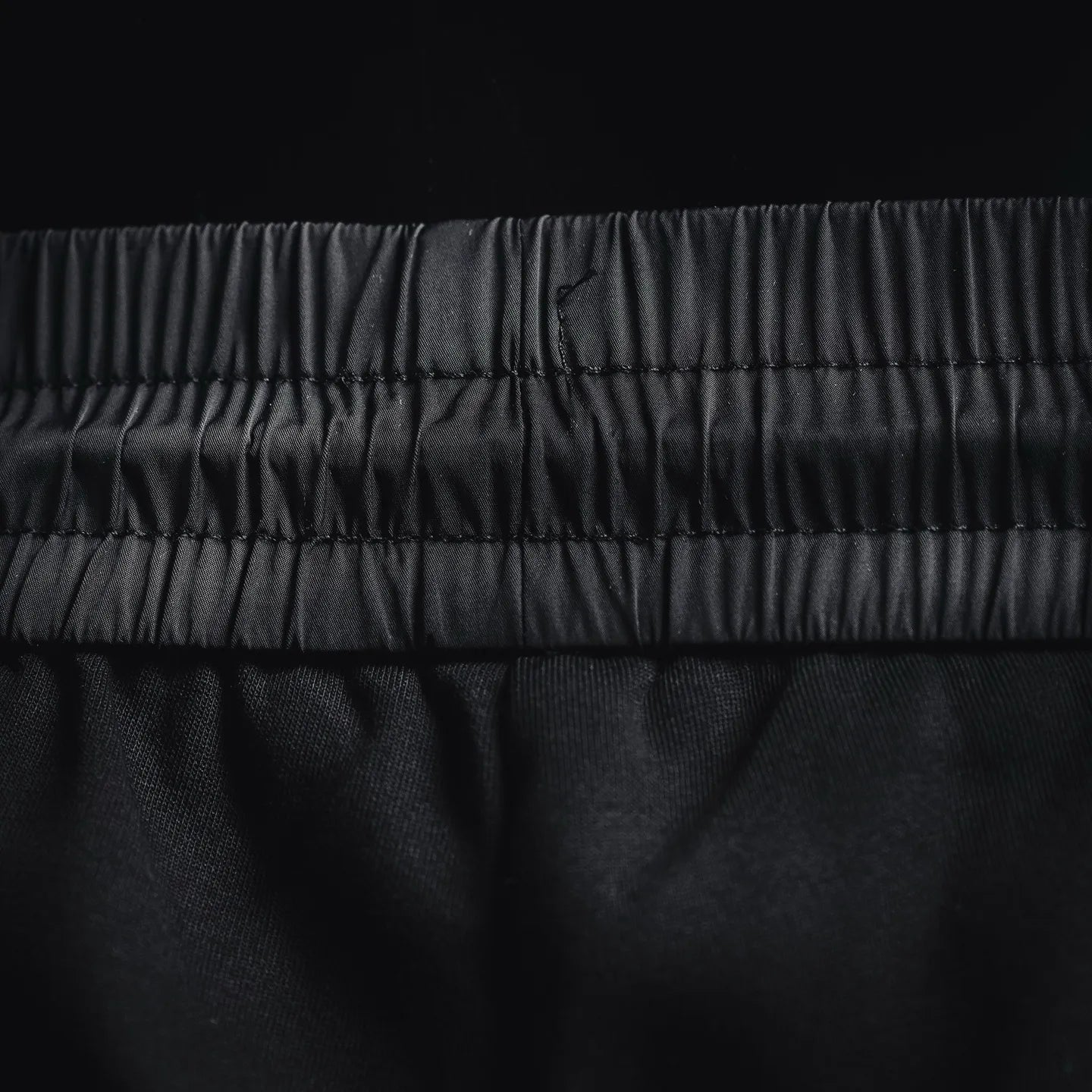 Prada black pants close-up of elastic waistband and stitched seams