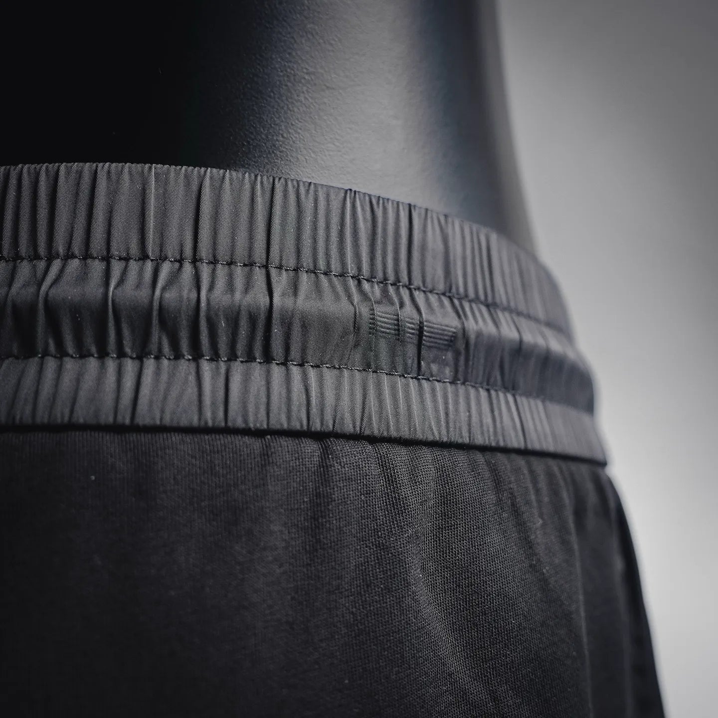 Prada black pants close-up of waistband ruffle and fabric texture