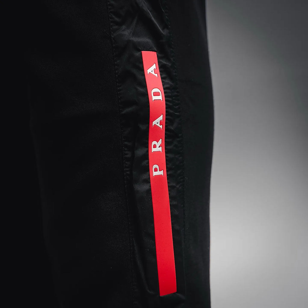 Prada black pants with red PRADA fabric tag on the side