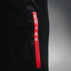 Prada black pants with red PRADA fabric tag on the side