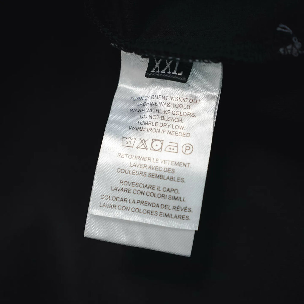 Prada black pants care label showing size XXL and washing instructions