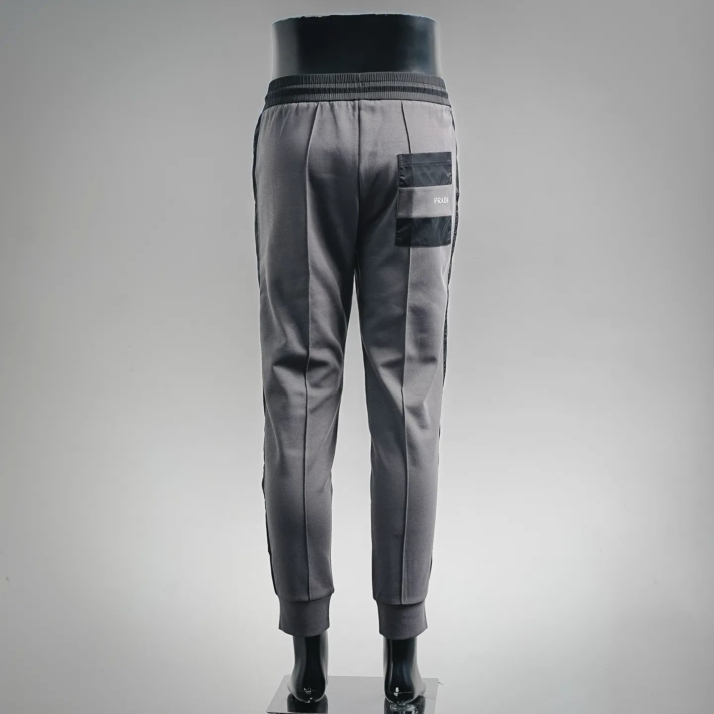 Prada dark gray jogger pants with back patch pocket and ribbed ankle cuffs
