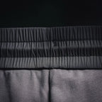 Prada elastic waistband seam detail on dark gray jogger pants