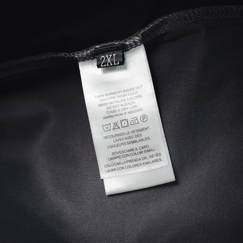 Prada pants care label tag marked “2XL” on dark fabric