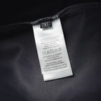 Prada pants care label tag marked “2XL” on dark fabric
