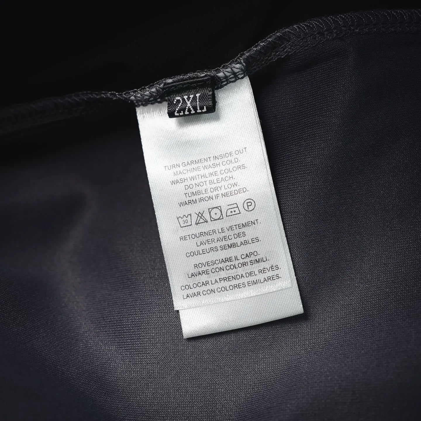 Prada pants care label tag marked “2XL” on dark fabric