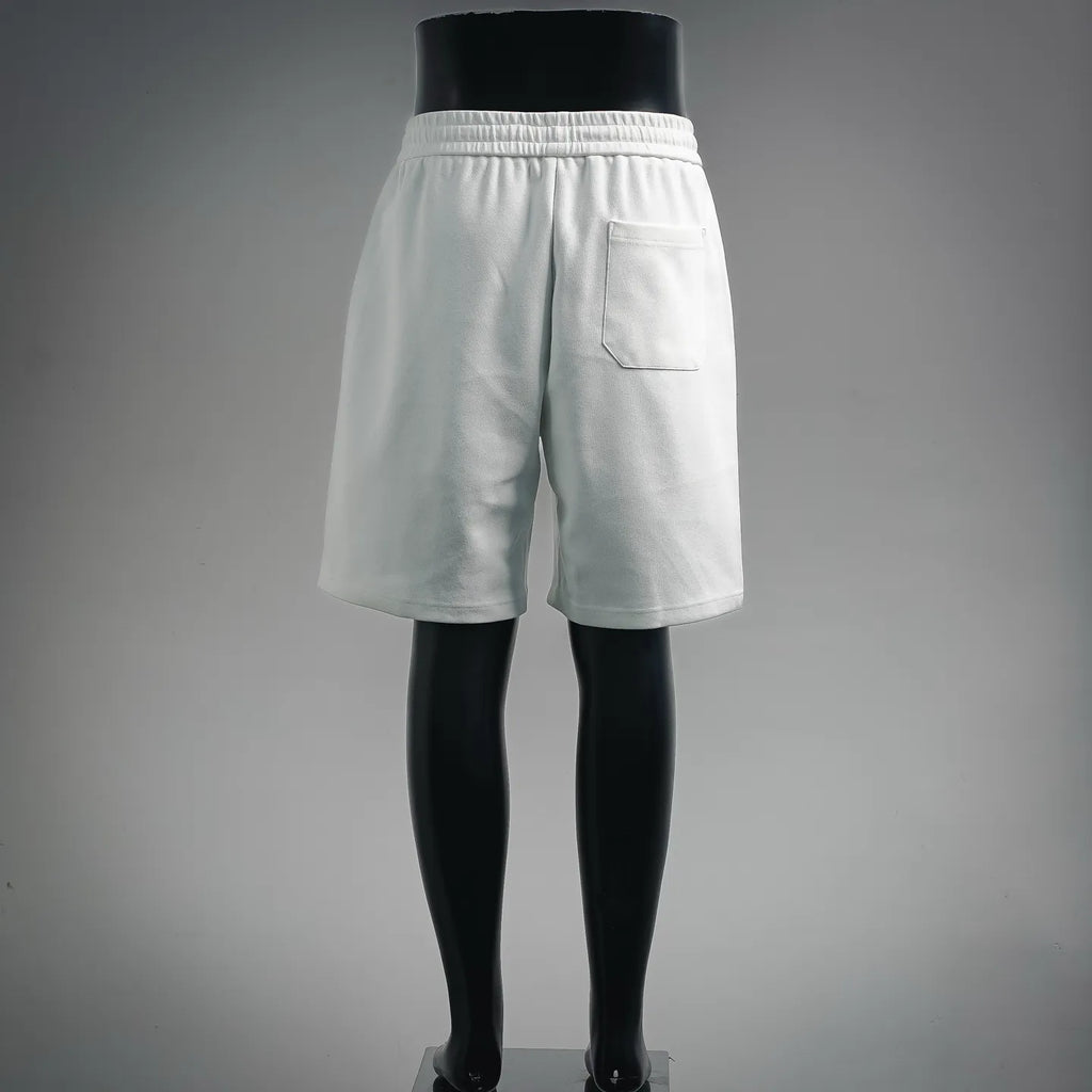 White Prada shorts with elastic waistband and side pocket, back view.