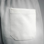 White Prada shorts front pocket with stitched opening detail.