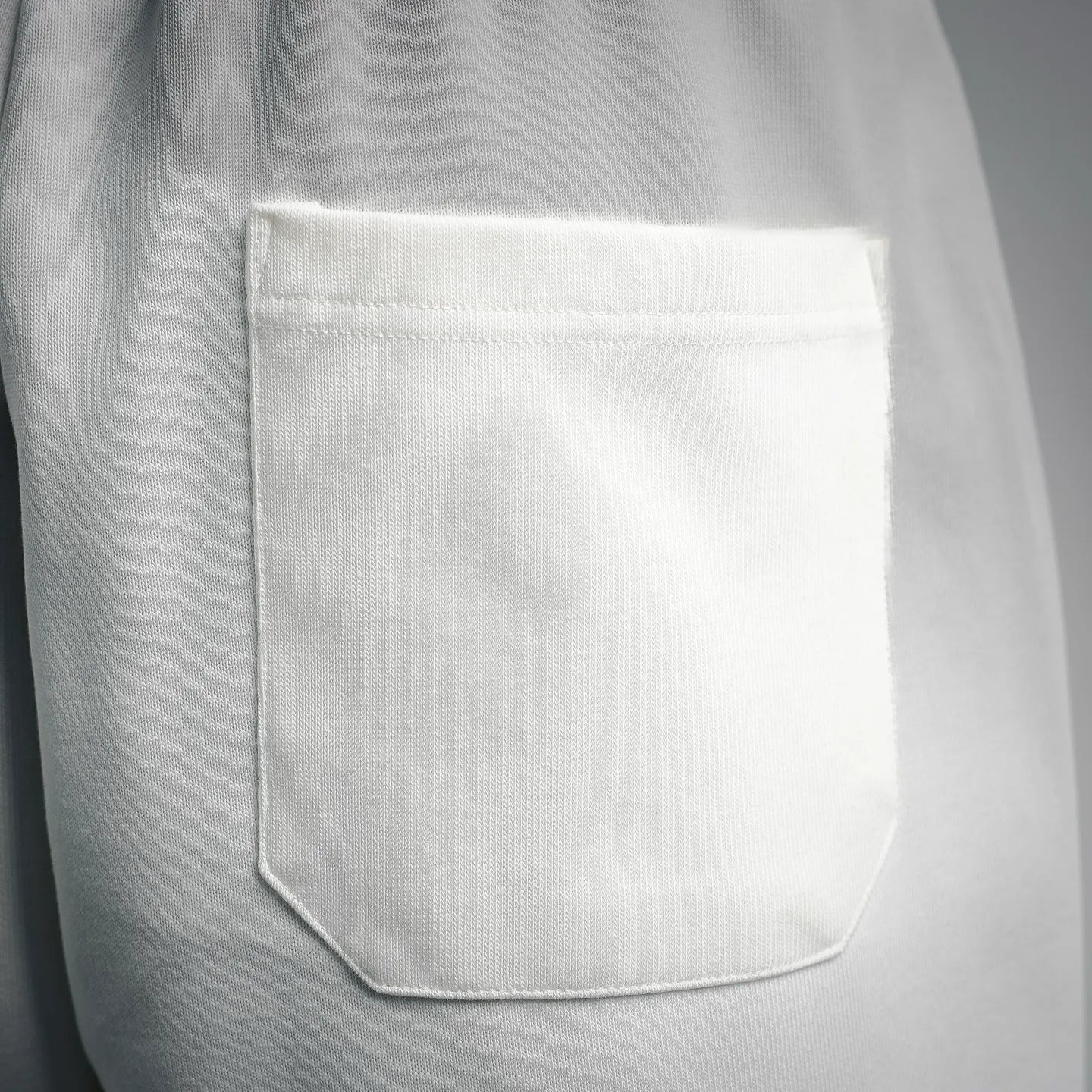 White Prada shorts front pocket with stitched opening detail.