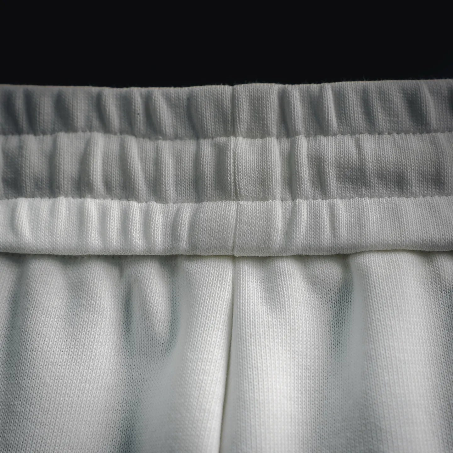 White Prada shorts elastic waistband with textured ribbing detail.