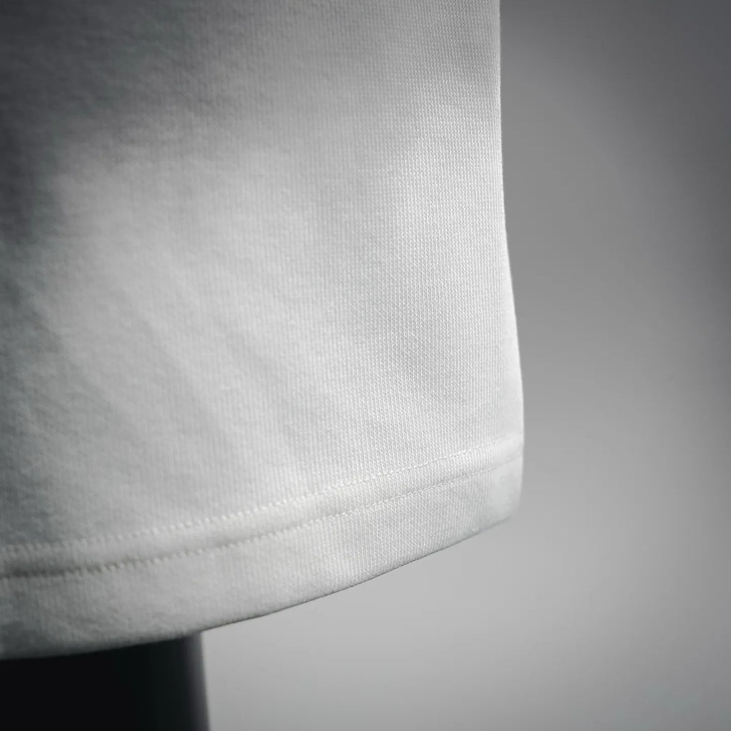 White Prada shorts hem with clean stitched edge detail.