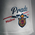 White Prada shorts front graphic logo print in blue and red.