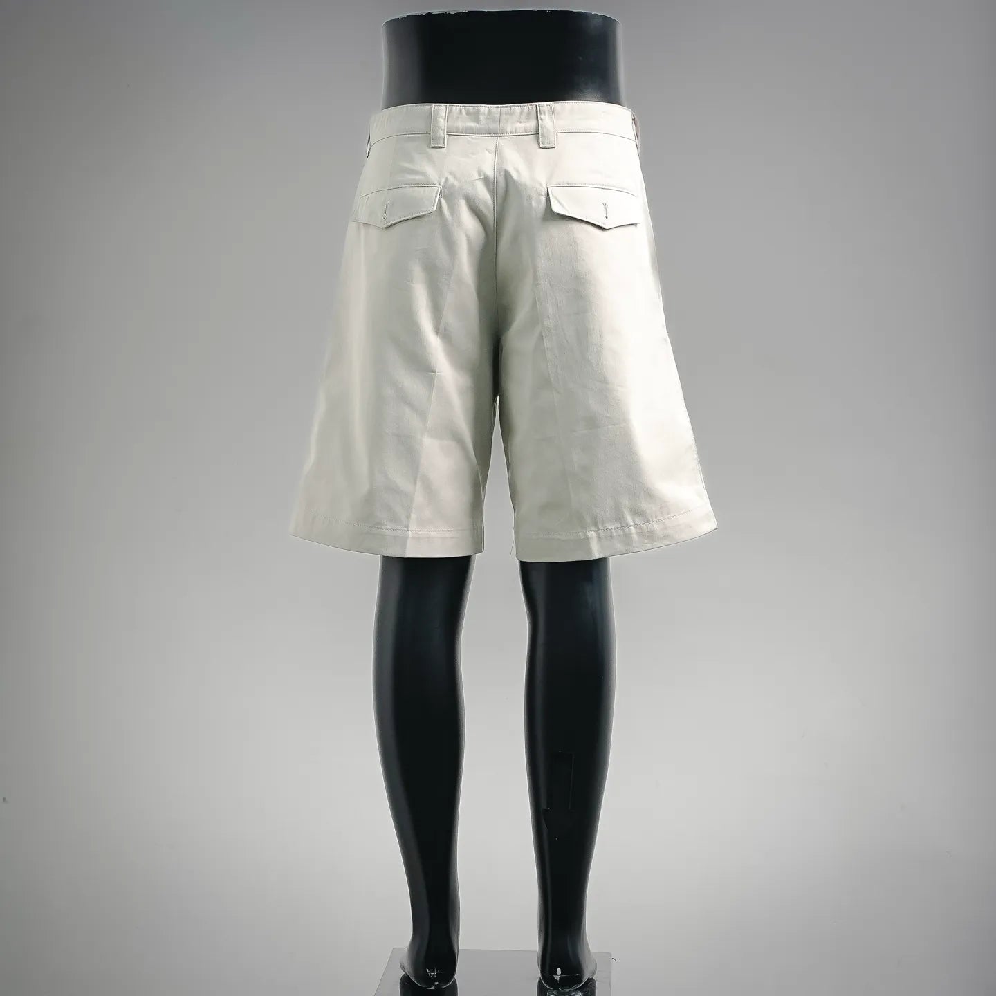 White tailored shorts, rear view with pockets and belt loops
