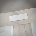 White shorts fabric label inside waistband with embossed text