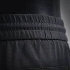 Black waistband with ribbed elastic and stitched seam