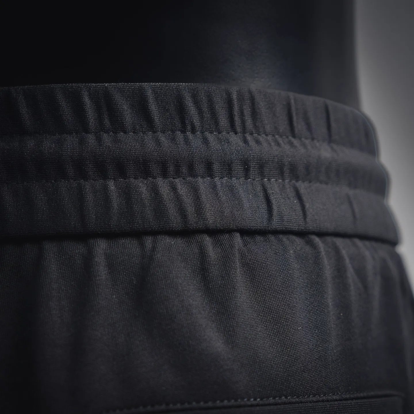 Black waistband with ribbed elastic and stitched seam