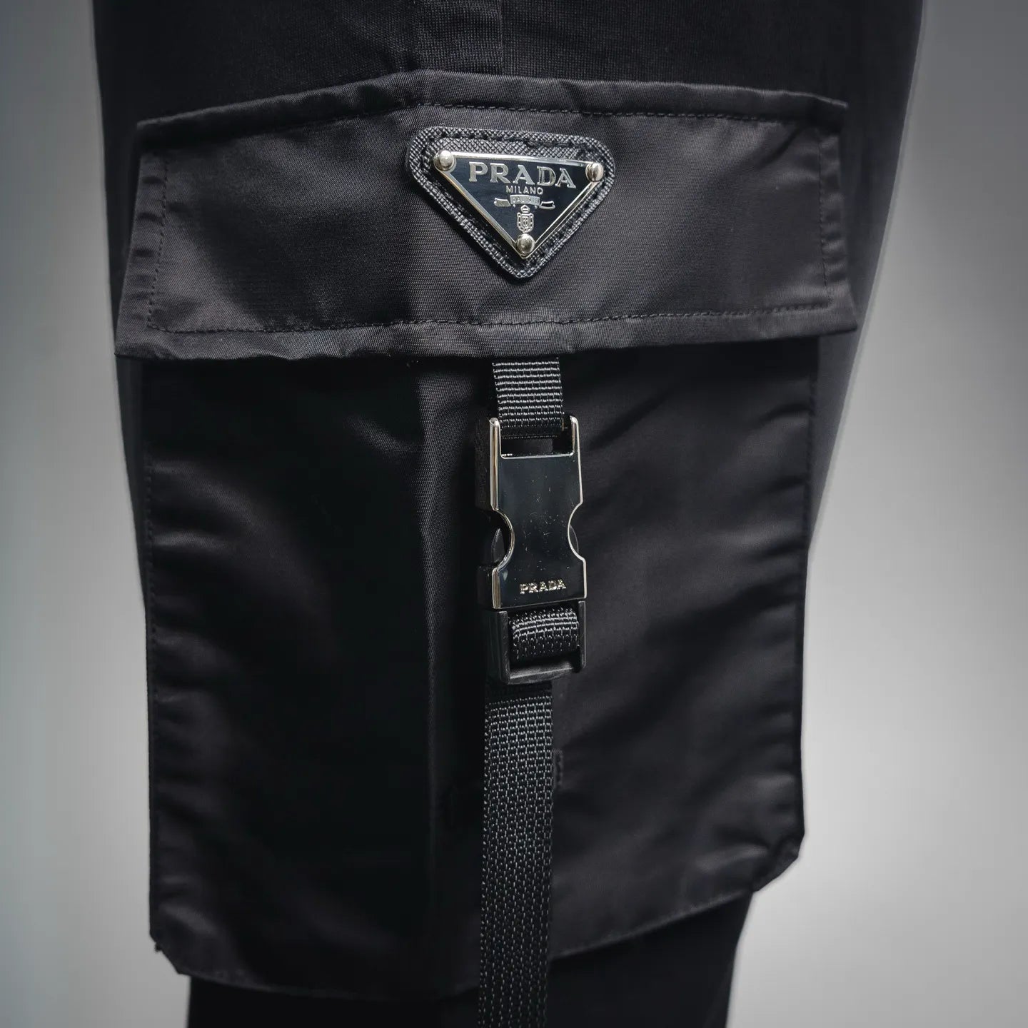 Black Prada side cargo pocket with woven strap and metal hardware