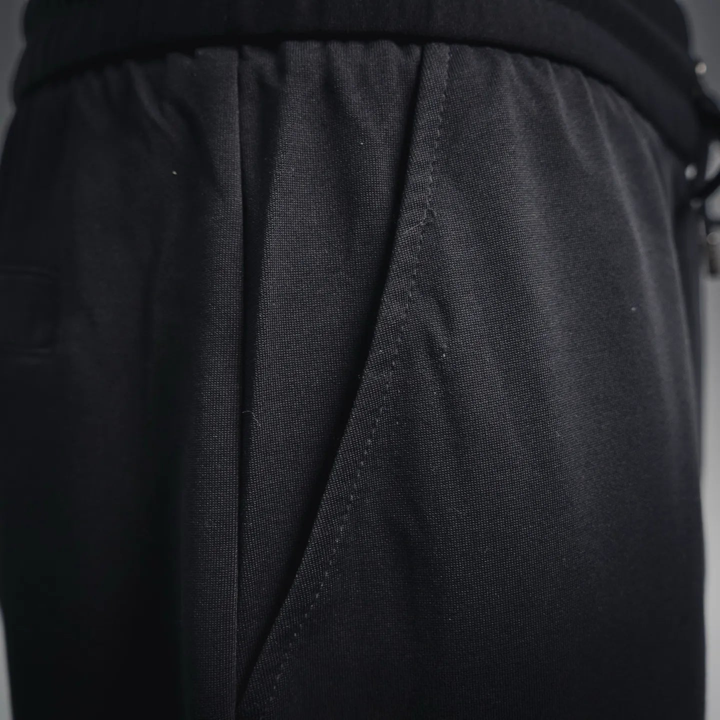 Black back panel with stitched seam and gathered waist drape