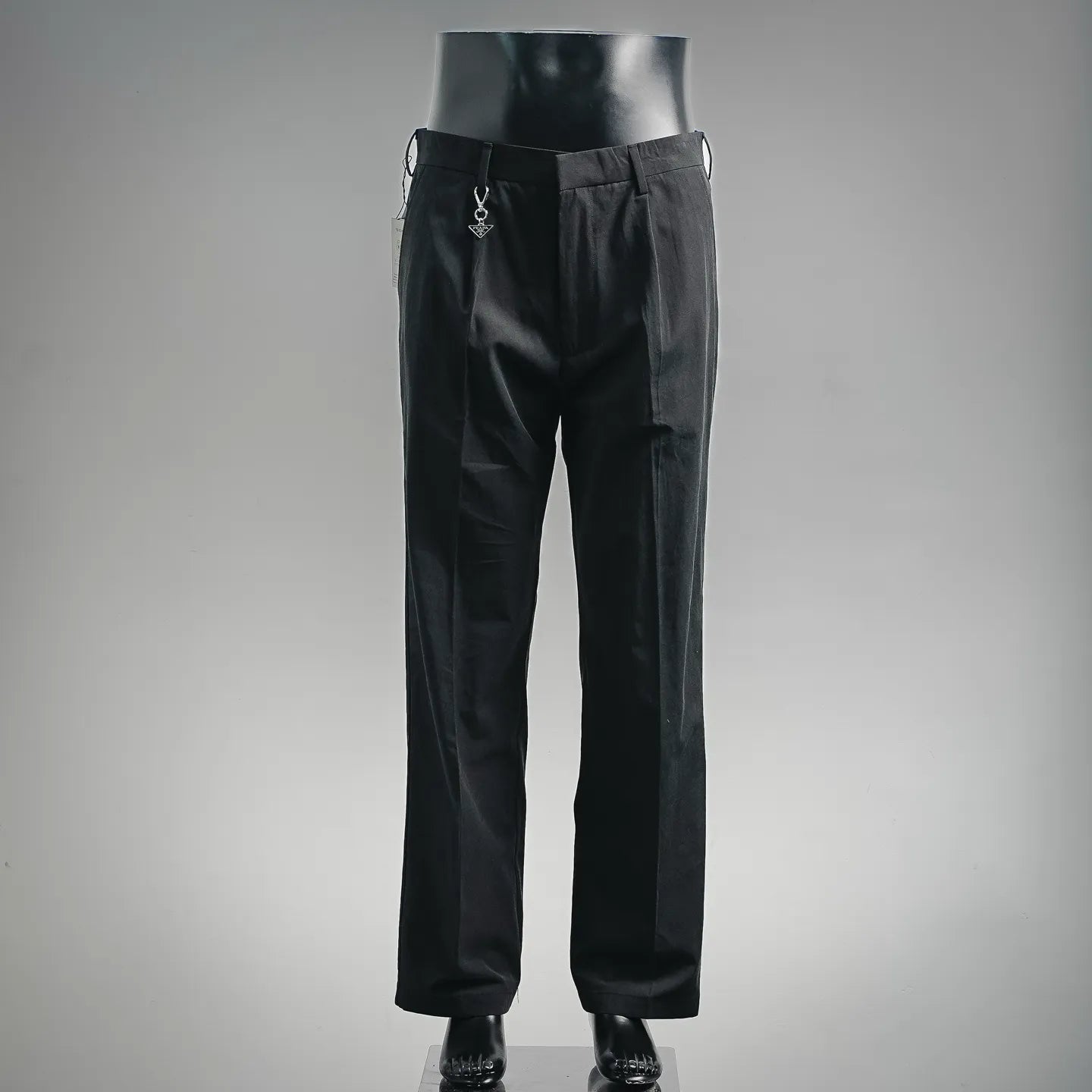 Black tailored pants with belt loops and front pleats