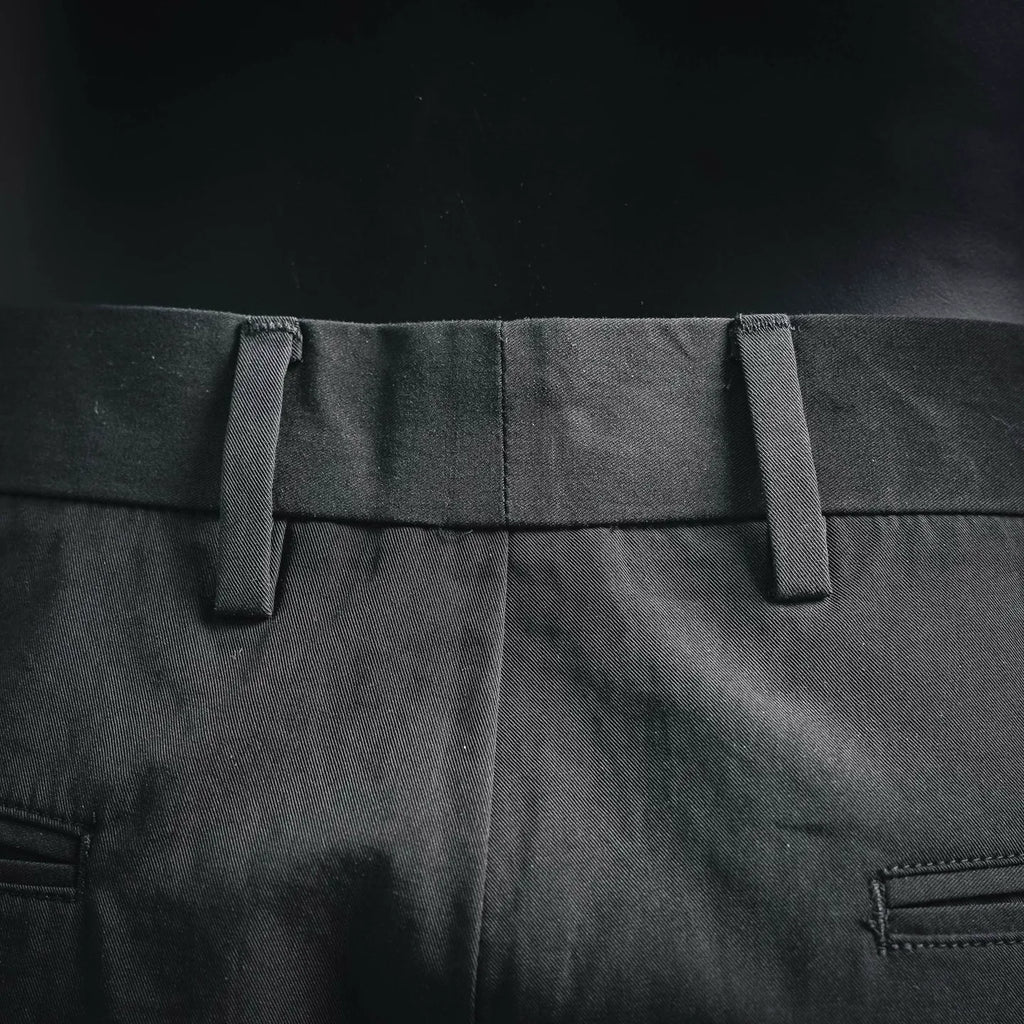 Black pant waistband with belt loops and stitched waist seam