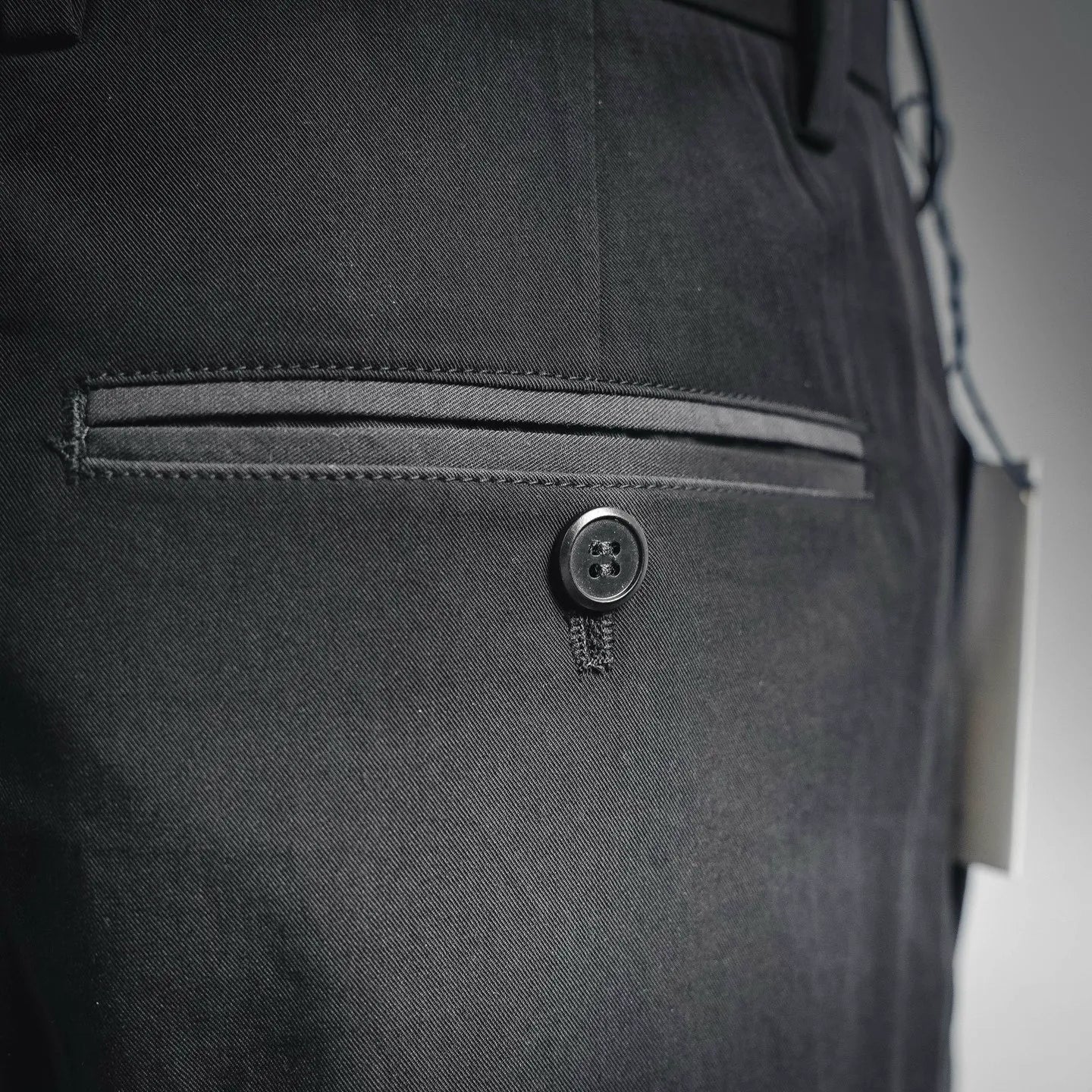 Black pant front with button closure and zipper fly