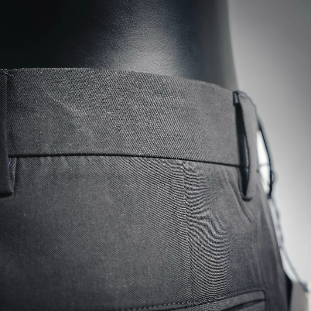 Black pant side waistband with button and stitched pocket opening