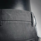 Black pant side waistband with button and stitched pocket opening