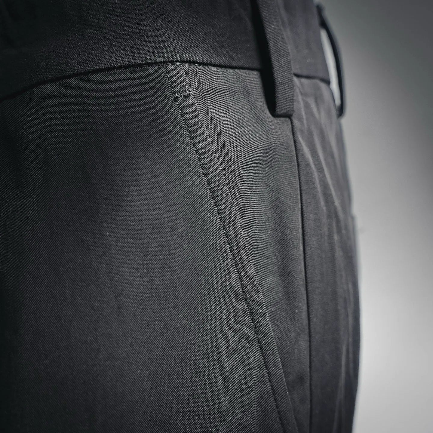 Black pant leg with side seam and stitched panel detail