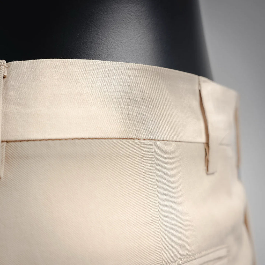 Beige Prada pants waistband area with belt loop and stitched fly