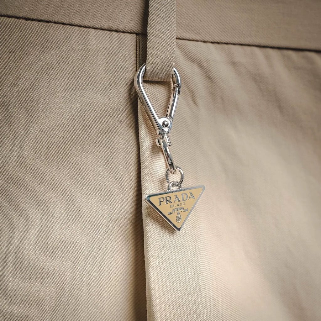 Beige Prada pants with metal clasp and Prada Milano leather tag