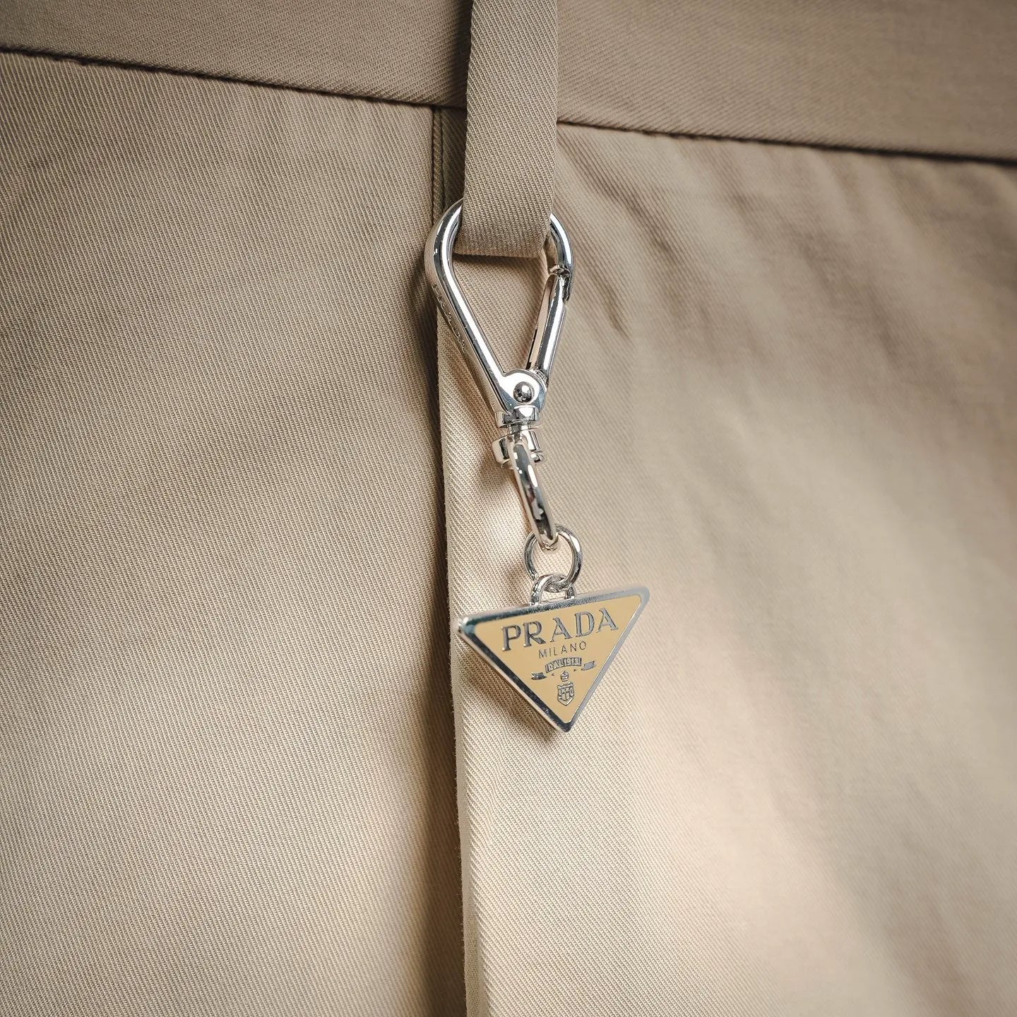 Beige Prada pants with metal clasp and Prada Milano leather tag