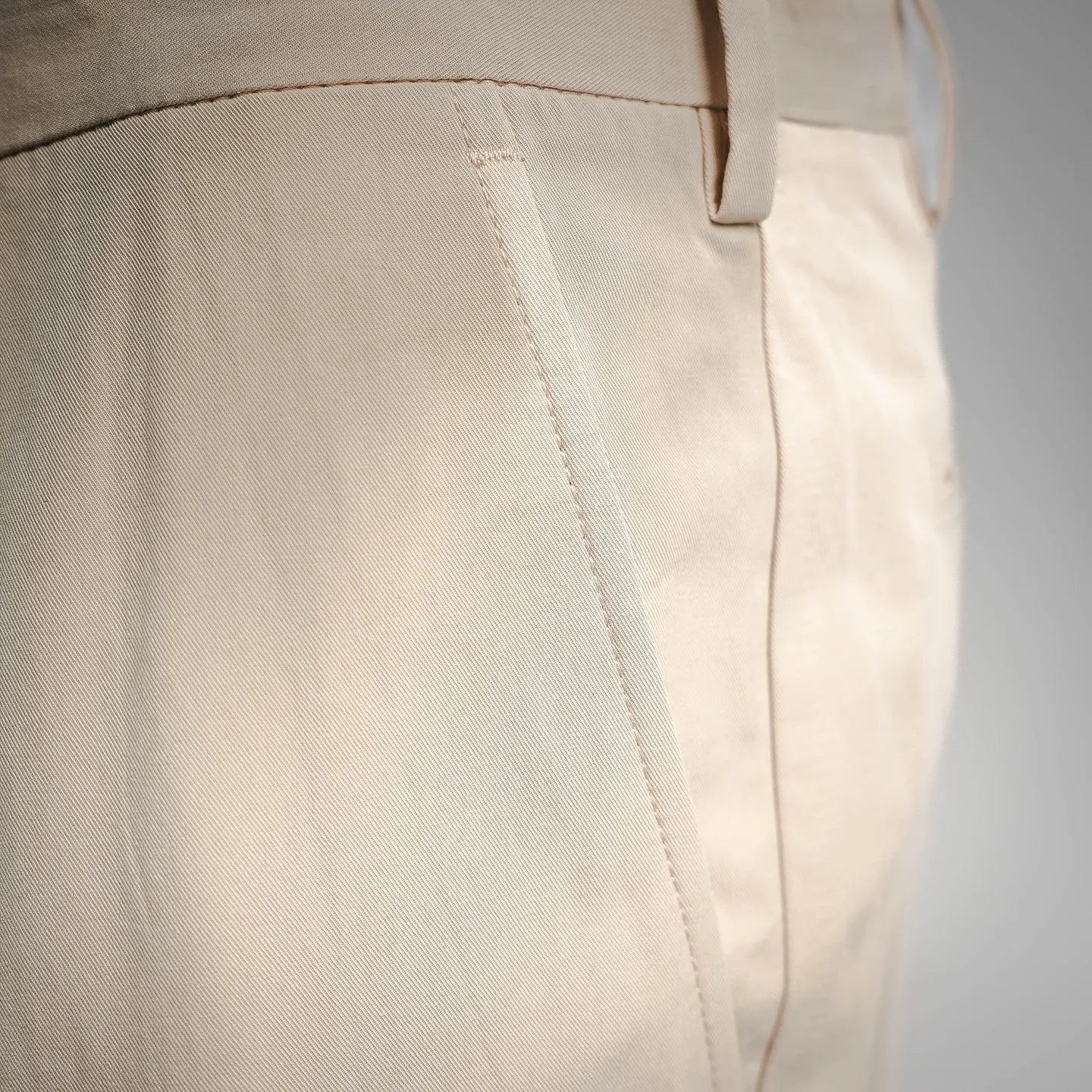 Beige Prada pants side seam and stitched waistband detail