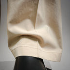 Beige Prada pants hem with cuff and stitched pocket opening
