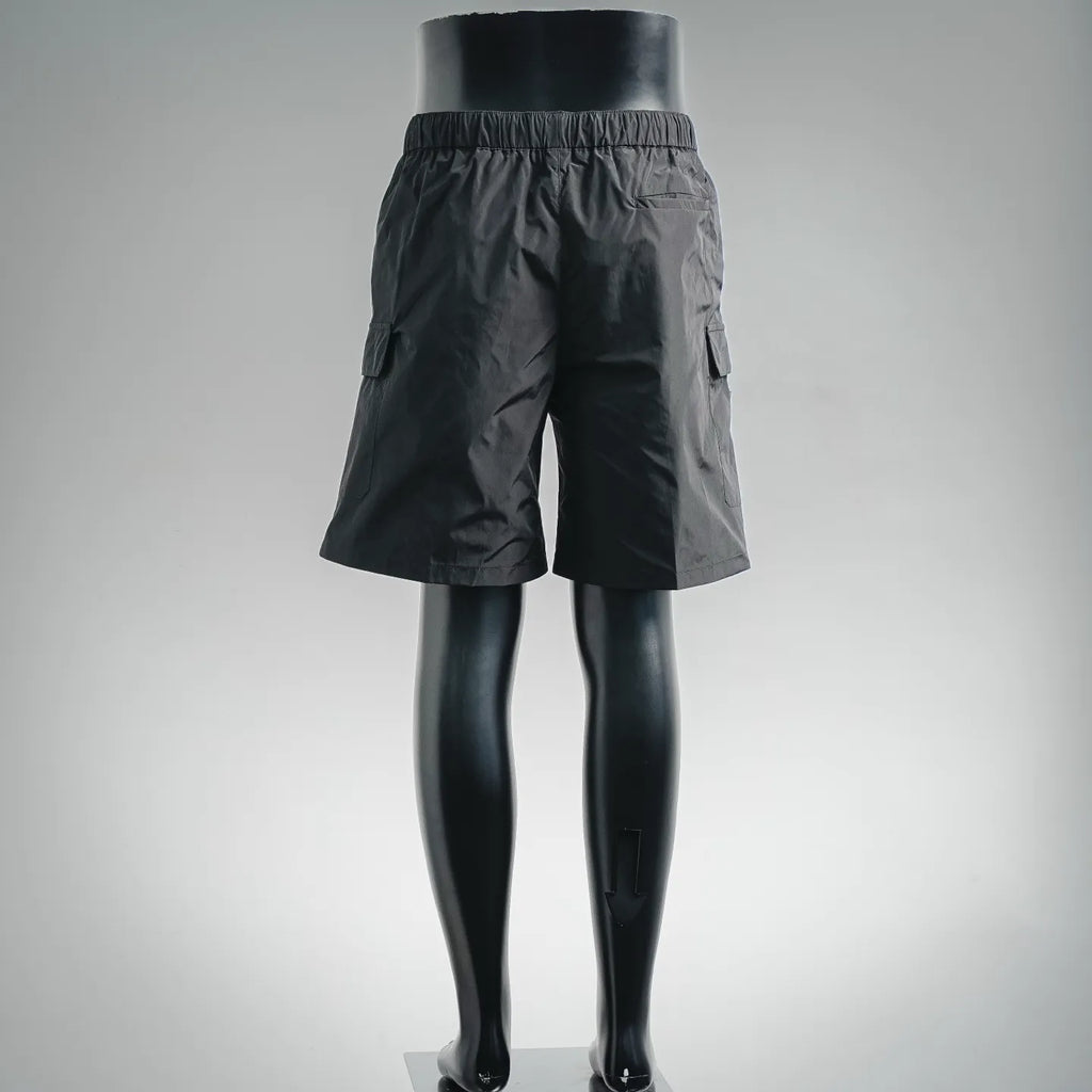 Dark nylon shorts-style pants with side pocket tabs and elastic waist
