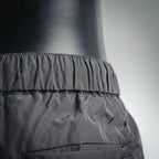 Dark nylon pants waistband and gathered front with stitched trim