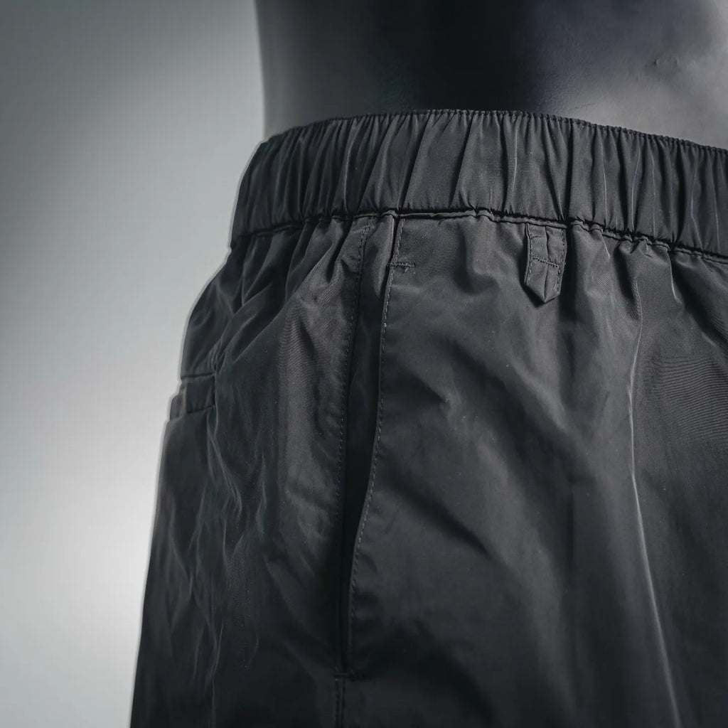 Dark nylon pants waistband with elastic and stitched seam details