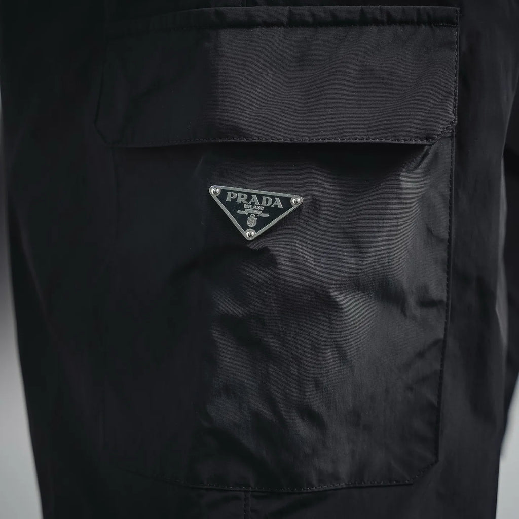 Dark nylon pocket with triangular Prada logo patch