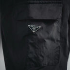 Dark nylon pocket with triangular Prada logo patch