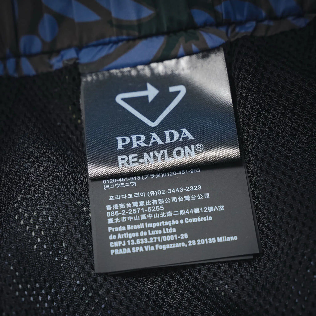 Prada RE-NYLON inner fabric label with care text on black mesh lining