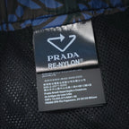 Prada RE-NYLON inner fabric label with care text on black mesh lining