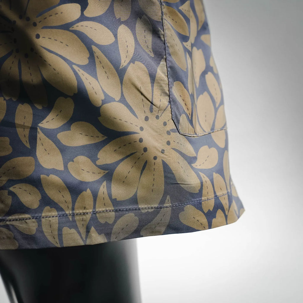 Blue and tan floral print shorts hem detail on Prada, side view