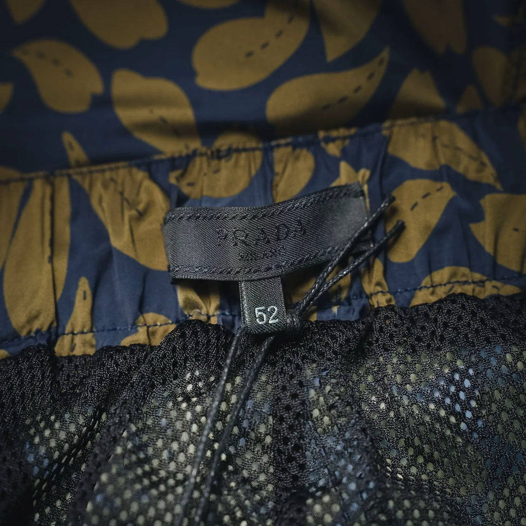 Prada size tag 52 at waistband on blue and tan floral shorts