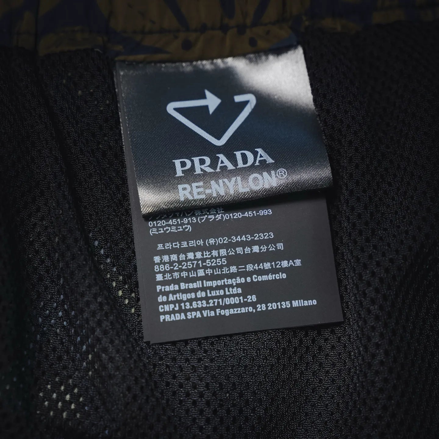 Prada RE-NYLON care label on black inner waistband, size and fabric info