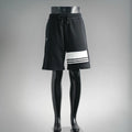 Black Prada drawstring shorts with white triple stripe at hem
