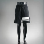 Black Prada drawstring shorts with white triple stripe at hem