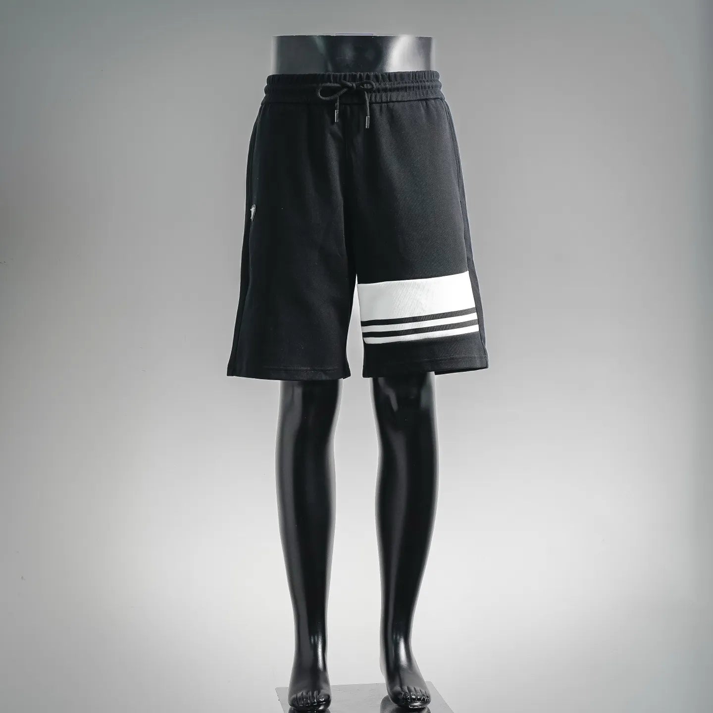 Black Prada drawstring shorts with white triple stripe at hem