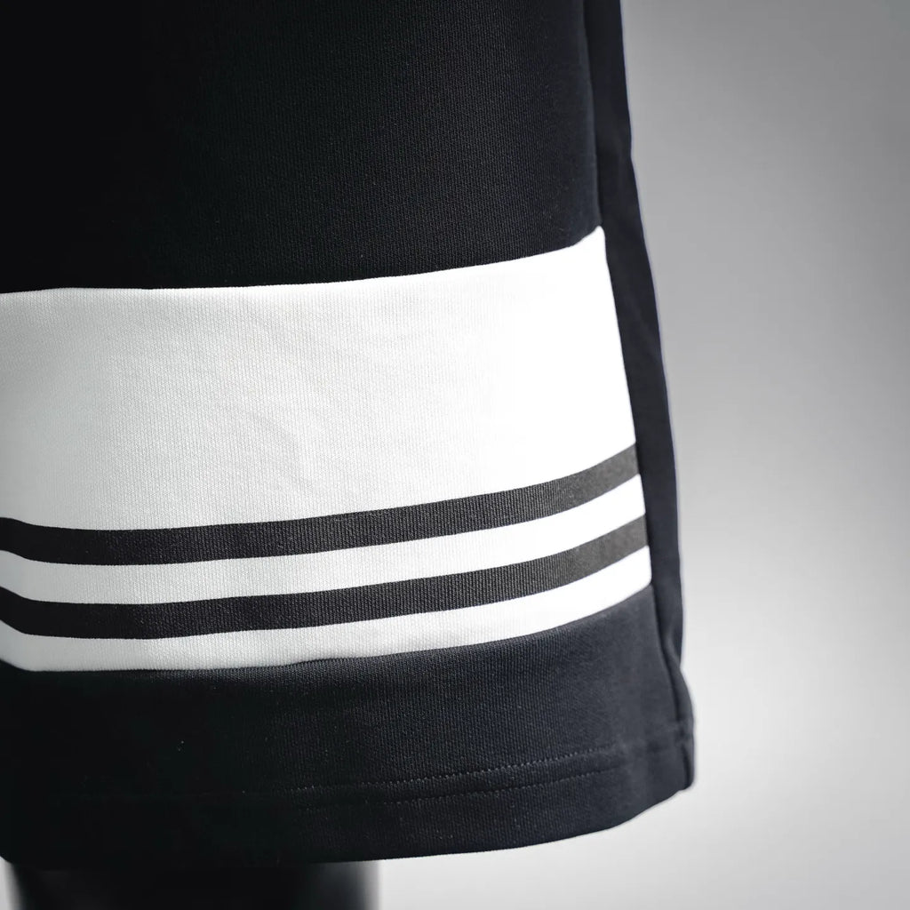 Black Prada shorts with white triple stripe band at bottom